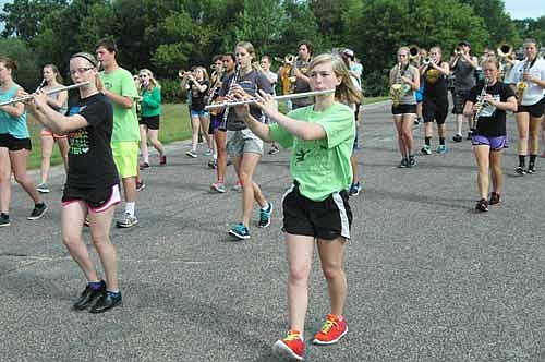 The Stewartville High School Marching Band took to the streets to work on its skills during the annual SHS Band Camp on Thursday morning, Aug. 6. From left, in front, Kaitlyn Newcome and Kylie Zea, flute players, and in the second row, from center, Jennifer Remling and Julia Lanzel, clarinet players, march in unison on Sixth Avenue Southwest just south of Stewartville High School.