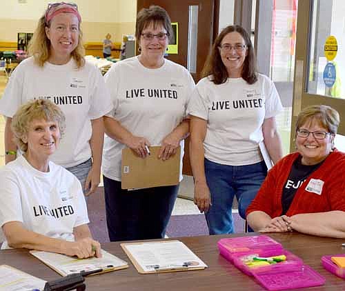 Helping during the United Way of Olmsted County's Running Start for School at Bonner School were from left, seated, Sharon Haarstad, Janet Miles Mallan, April Schumann, Sherry Paynic, and Mary Jo Tittl, seated. Mary Jo works at United Way as a Community Impact Specialist, but was serving as a volunteer at distribution. She is a Stewartville resident.
