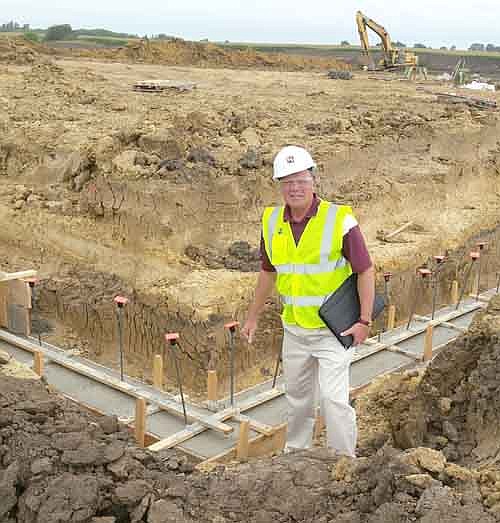 Dr. David Thompson, superintendent of Stewartvile schools, stands near the new footings that have been put in place for the construction of the new school for students in grades three through five. The school is being built just north of Bear Cave Park.