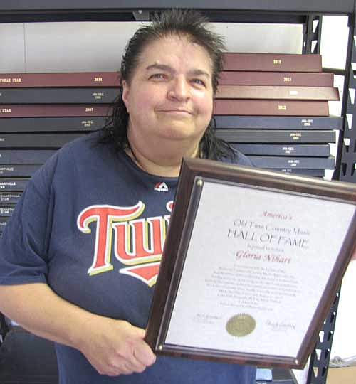 Gloria Nihart of Stewartville holds the plaque that declares her a member of the Old Time Country Music Hall of Fame.