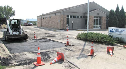 Workers from Rochester Asphalt fixed the large potholes in the parking lot at the Stewartville Post Office last week.