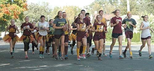 The Stewartville cross country team made the long run from Plainview to deliver the game ball to the Tiger football team for the homecoming game against PEM.