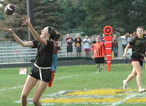 Junior receiver Olivia Waltman is wide open to make a great catch down field during the homecoming powder puff football game on Sept. 25.