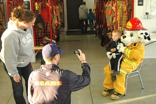 Ethan Engen, 2 1/2, of Stewartville poses with Sparky the Fire Dog as Jason Engen, Ethan's dad, takes a photo.