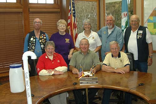 Mayor Jimmie-John King, seated in center, signed a proclamation last week declaring Saturday, Oct. 17 as White Cane Day in the city of Stewartville. On that day, members of the Stewartville Morning Lions Club will collect donations for the Minnesota Lions Vision Foundation, which includes the Macular Degeneration Center, the Adult Eye Bank and the Children's Eye Bank, all affiliated with the University of Minnesota. Several of the members of the Morning Lions Club who will collect donations include, front row, from left, Kay Tvedt, chair of White Cane Day, and Len Griffith. Back row, from left, Ron Piedmont, Suzanne Piedmont, Sheila Majerus, Dave Hoot and Wayne Freiheit.