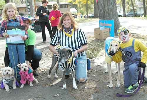 Aiden Timm and his dog, Sobe, right, won first place in the Pets in the Park Costume Contest. Sobe dressed as a minion. Greta Ravenhorst of Racine and her dogs, Lennon and Buddy, left, placed second. Sharon Pooler and her boxer, Chance, center, placed third.