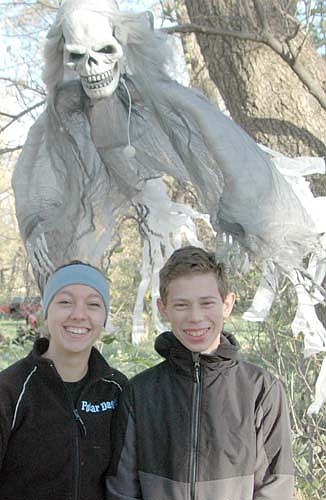 Jade Schmeling, a junior at Edina High School, left, and her cousin Gabe Nelson, a freshman at Stewartville High School, don't seem concerned that a spooky creature is hanging around behind their backs. Schmeling and Nelson hosted the fourth annual Spook City in the Woods in rural Racine on Oct. 17 and 18.