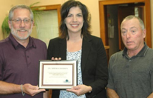 Margaret Nelson, Stewartville's State Farm Insurance Agent, center, accepts the Economic Development Authority's Business Appreciation Award from Chris Stafford, EDA president, left, and Mayor Jimmie-John King.