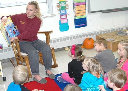 Marie Larson, a senior at Stewartville High School, is one of 18 high school students who read stories to the students at Bonner Elementary School on Tuesday, Oct. 27. The stories focused on what students can do to prevent bullying. Larson read The Recess Queen, a book about Mean Jean the Recess Queen.  Larson told the students that it's difficult to play with people who are mean. "How can we be kind to someone?" she asked. "Ask them if they want to play," one student responded. 