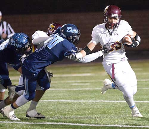 Running back Jordan Johnson chops the arm of a Becker tackler to pop outside on a big ground gainer.
