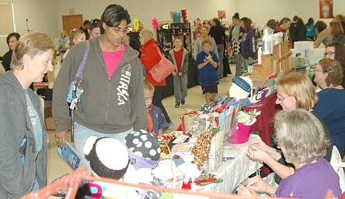 Julie Hayes of Stewartville, far left, and her daughter Kristal were among hundreds of shoppers who attended the Stewartville Holiday Boutique at the Civic Center on Saturday morning, Nov. 7. "I come just to see all the wonderful things people create," Hayes said. "They do a wonderful job. It's a good local event."