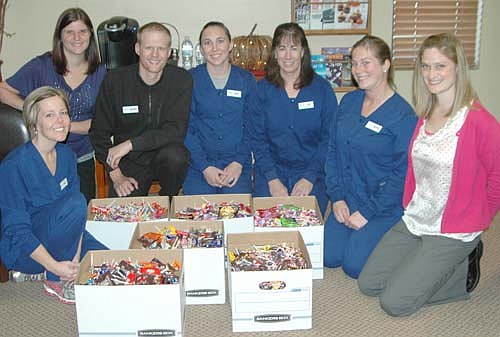 Root River Dental of Stewartville collected about 150 pounds of candy the week after Halloween during its second annual Buy Back for the Troops initiative. Children who turned in their Halloween candy received $1 per pound for up to five pounds of candy. Zachary Lechner's dental office sent the candy to Operation Gratitude, an organization that sends care packages to U.S. servicemen and women. Root River Dental employees posing with the candy include, from left, Kelly Krumm, Kortney Miller, Zachary Lechner, DDS; Kayla Gibson, Sue Weber, Brianna Elwood and Heather Bucknell.
