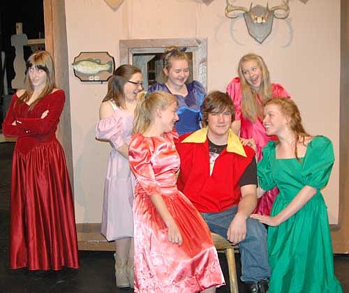 Belle (Calli McCartan), far left, is annoyed by Gaston's (Morgan Wildeman)&#8200;seated in center, continual proposals while the Silly Girls, clockwise from left, Ellie Fryer, Amelia Welter, Jenny Stageberg, Gloria Nelson and Bobbie Hart, surround Gaston to try to win him for themselves during a dress rehearsal for Stewartville High School's upcoming production of the timeless classic Beauty and the Beast.