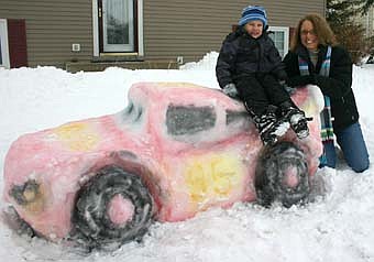 SNOW CAR -- Cathy Stone and her son Ethan, 4, worked together for about two hours to build a replica of "Lightning McQueen" from the "Cars" movie in their front yard at 602 Third Avenue Southeast last week. 