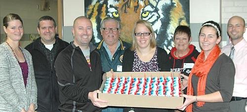 Members of the Stewartville American Legion Post 164 and Auxiliary Unit 164 celebrated American Education Week (Nov. 16-20) last week by delivering cupcakes to educators at Stewartville High School and Middle School, above, and to the staffs at Bonner Elementary School and Central Intermediate School. Richard Paulson of the Legion, fourth from left, and Peggy Paulson of the Legion Auxiliary, third from right, delivered the cupcakes to educators, from left, Jessica Honsey, Charlie Aitken, Jim Parry, Chelsey Johnson, Kristin Remick and Ramsey Miller.
