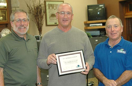 Glenn Lutteke, general manager of All-American Co-op in Stewartville, center, accepts the Economic Development Authority's Business Appreciation Award from Chris Stafford, EDA president, left, and Mayor Jimmie-John King, also an EDA&#8200;member.
