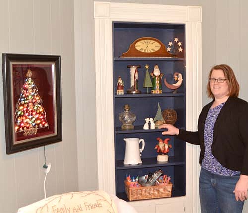 Emily Christie displays some of the decorations at her home at 304 Third Street Southwest.