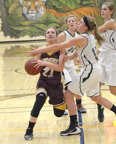 Lori Bailey drives the lane, drawing defenders and a foul on this layup attempt against La Crescent.