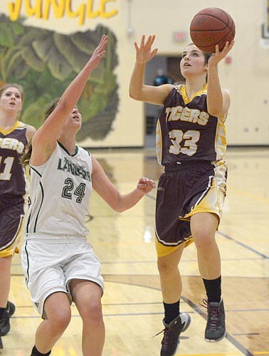 Hunter Miller eyes the hoop as she converts on this fast break bucket in Stewie's 27-point win over La Crescent.