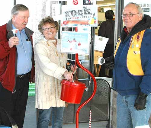 Wenda Grabau of Spring Valley places a donation in the kettle as Chuck Murphy, left, and Dick Uptagrafft of the Stewartville Lions Club ring bells for the Salvation Army at Fareway in Stewartville. At least 48 members of the Stewartville Lions will ring the bells at Fareway for a total of 50 hours through Thursday, Dec. 17. All the proceeds will go to the Salvation Army. "We have great success doing this," Murphy said. "People are very generous."