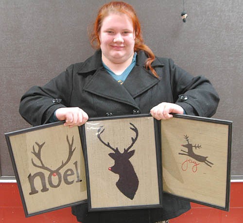 Samantha Bush, a senior at Stewartville High School, displays her burlap paintings which will be up for sale at the SHS Silent Art Auction this Sunday, Dec. 13 at 4 p.m.