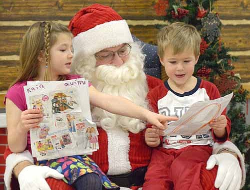 Kaia Bicknese, 6, left, points out her younger brother Quinn's favorite gift at the Stewartville Kiwanis Club's annual Pictures with Santa event at the Stewartville Civic Center on Saturday, Dec. 5.  Quinn, 3, Kaia and hundreds of other Stewartville and area children shared their Christmas wishes with the jolly man in the red suit from just after 9 a.m. until about 12:20 p.m. that day. Proceeds from the event will help pay for scholarships for Stewartville High School students. More photos of children visiting with Santa will appear in the Stewartville STAR Holiday Section on Tuesday, Dec. 22.