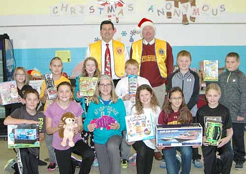 Students at Central Intermediate School have donated many gifts to the Stewartville Lions Club's 2015 Christmas Anonymous gift and fund drive. Troy Knutson, in back at left, and Bill Schimmel Jr. of the Stewartville Lions visited Central on Friday, Dec. 4 to pack the presents into a vehicle and take them to a distribution site in Rochester, where they will be given to children who otherwise might not receive a Christmas present. Students posing with the gifts include, front row, from left, Titan Klunder, Emily Lamb, Ashley Anderson, Addison Eide, Emma Rowen and Chloe Biever. Back row, from left, Gabi Hameister, Braeden Hastings, Addison Manley, Trey Cast, Logan Skustad and Kjell Lunaas. Also, students Kiley Jones, left, and Zachary Hanson are in the inset photo at upper left.