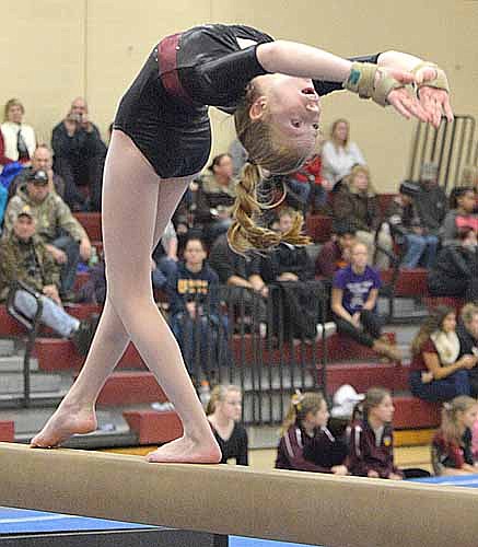 Sydney Van Moer executes a back walkover on the beam against PI.