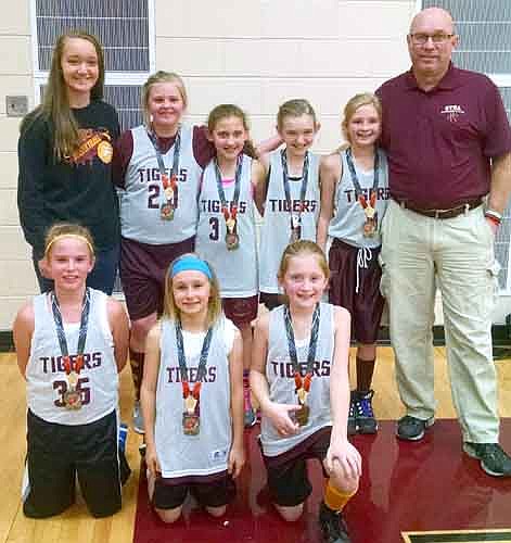 The Stewartville Youth Basketball Association 4th grade girls basketball team captured first place at the Triton Tournament on Dec. 19. The Tigers defeated Byron 27-21 in their first game, won 34-13 over Lake City in their second game and beat Austin 24-16 in the championship game. Team members are, kneeling, from left, Taylor Klement, Katrina McClusky, McKenna O'Neill. Standing from left, Asst. Coach Marie Rindahl, Lilly Beyer, Ayan DeCook, Caitlyn Fenske, Arbor Weinhold, Coach Scott Rindahl.