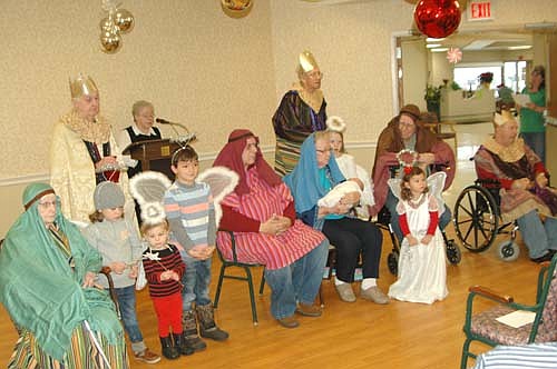 A large audience of residents and guests watched the annual live Nativity at the Stewartville Care Center on Christmas Eve morning, Thursday, Dec. 24. Charlotte Kath, seated and dressed in blue, was the Blessed Virgin Mary and Gary Boyum, seated in red, was Joseph. Cas Roeder, 5 weeks old, was a calm and quiet Baby Jesus. Others in the cast included David Wendt, Wes Glover and Ray Molde as the Wise Men; Ethel Bissen and Cliff Walker as shepherds; and Karisa Stevens, Ellieana Miller, and Bram, Daxton and Hazel Roeder as angels.