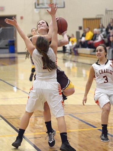 Kyleigh Wangen draws a blocking foul, driving from the wing.