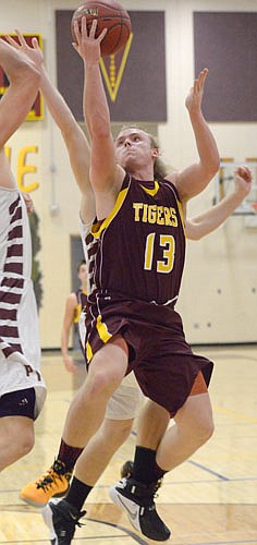 Ty Smidt gets hacked from behind as he attacks the rim on this driving layup in Stewie's 53-49 win over Pine Island.