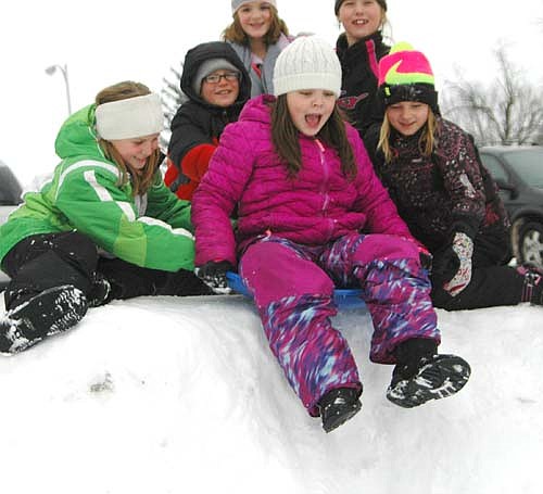 T'ea Odegaard Burzette, a third grader, above center, contemplates the big drop-off at the top of the snow hill near Central Intermediate School as fellow third graders, from left, Kylie Minnich, Broc Mullenbach, Alexis Petersen, Syvannah Pugh and Nevaeh Mayer prepare to push on Thursday, Jan. 7.
