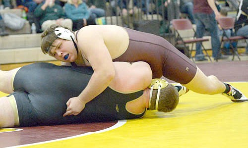 Kyle Lipkie circles to get chest-to-chest and drives the shoulders of his 285-pound Caledonia opponent to the mat before pinning him.