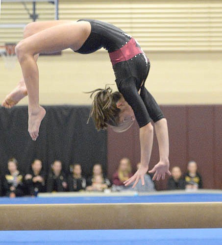 Mariah Terhaar executes a backward handspring during her beam routine against Byron.