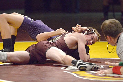 Joey Thompson drives down the shoulders and lifts the head of his 126-pound Goodhue opponent, as the ref slaps the mat awarding Thompson the pin.