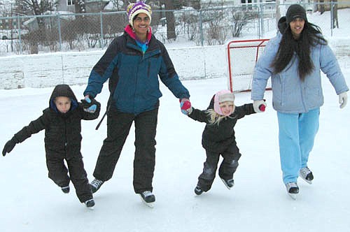 Kristal Hayes, second from left, and her son Dayton, far left; join Sonja Hayes, far right, and Sonja's daughter Chanielle, second from right, in a family skate across the city of Stewartville's hockey rink at Florence Park on Friday, Jan. 22.