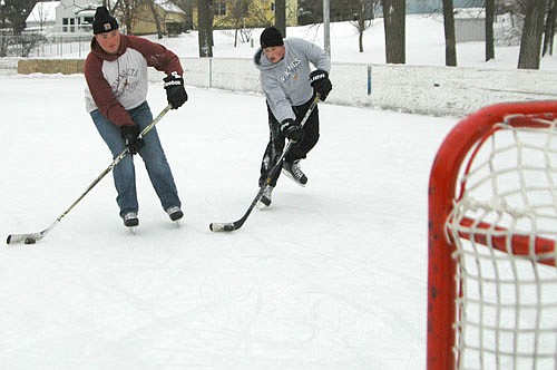 Justin Lonien, left, and his younger brother Luke practiced their stickhandling and shooting skills at the city of Stewartville's hockey rink at Florence Park on Thursday afternoon, Jan. 21. The day was good for skating, with temperatures in the low 20s and virtually no wind.