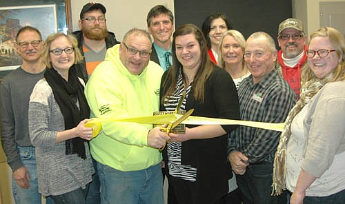 An open house and ribbon cutting for Sunshine Sanitation's new location was held at 520 Main Street South on Wednesday, Jan. 20 from 4:30 p.m. to 7 p.m. Tory Keefe, owner, second from left in the front row, cuts the ribbon as Misty Nibbe, a Sunshine Sanitation employee, holds a Chamber plaque. Holding or standing near the ribbon in the front row are, from left, Melissa Leuning, Chamber president, Mayor Jimmie-John King and Gwen Ravenhorst, Chamber administrator. Chamber members on hand to welcome Sunshine Sanitation include, in back, from left, Al Chihak, Ryan Ravenhorst, Jarett Jones, Margaret Nelson, and Connie and Curt Grisim.