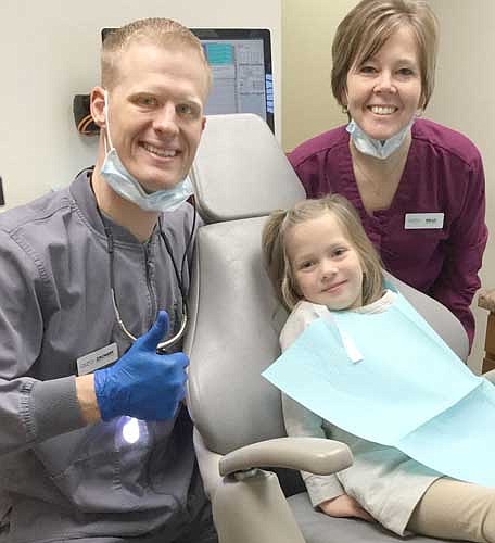 Dr. Zachary Lechner, left, and the Root River Dental staff hosted the second annual Give Kids a Smile community event on Friday, Feb. 5. The event raises awareness that February is National Children's Dental Health Month and that children need good oral health care. This year, the Root River Dental team offered free exams, cleanings, X-rays and restorative treatments to 10 children in need. "We are excited to be able to provide care to families that otherwise wouldn't have access to dentists and hygienists," Lechner said. Above, Addi Bernau sits in the dentist's chair and waits for treatment from Lechner, left, and Kelly Krumm.