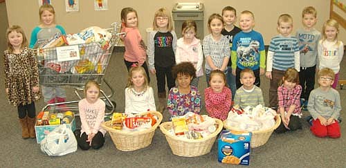 Children at St. John's Wee Care in Stewartville display the nonperishable food items Wee Care families recently donated to the Channel One Food Shelf in Rochester.