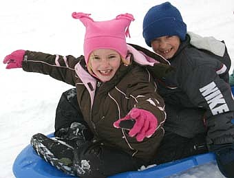 Bonner Elementary School students enjoyed jumping on their sleds and heading down the hill near the school during recess last week. Here, first-graders Marisa Goff and Dylan Flink ride smoothly atop the snow. The snow was deep and sticky, preventing the students from picking up too much speed, but the kids had fun anyway. 