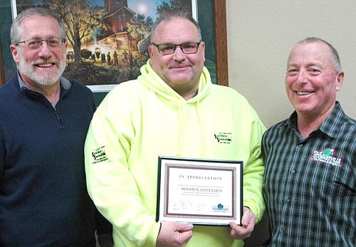 Tory Keefe, owner of Sunshine Sanitation, center, accepts the EDA Business Appreciation Award from Chris Stafford, EDA president, left, and Mayor Jimmie-John King, a member of the EDA.