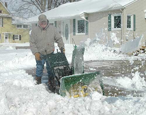 Gib Fjelstad of Stewartville uses his snowblower to clear a path near his house on Third Street Northwest after a storm dumped about 10.5 inches of snow on Stewartville and the area on Wednesday, March 23 and Thursday, March 24.