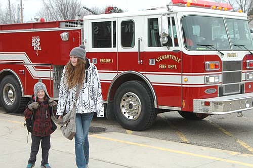 Cole Adkins, a kindergartner, rode to school in a Stewartville Fire Department fire truck on Monday morning, April 4. Cole's name was selected in a drawing open to all Bonner students who raised $20 or more for the school's recent Jump Rope for Heart activity. Nicole Fay, Cole's mom, is at right.