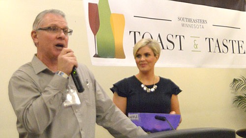 Jeff Beyer, chairman of the Stewartville Park Board and a trustee with the Stewartville Area Community Foundation, above left, speaks to the large audience at the Rochester International Event Center at the Foundation's first annual Toast & Taste on Friday evening, April 1. The event was held to raise funds for a new amphitheater planned for Bear Cave Park. Rachel Wick, anchor and news reporter for KAAL-TV, above right, was the master of ceremonies for the event, which drew about 450 people.  Those in attendance, pictured below, browsed through the numerous silent auction items during the Toast & Taste event.