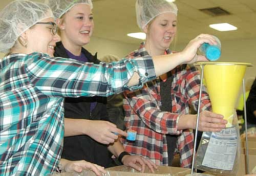 From left, Whitney Johnson, Courtney Hanson and Shelby Paaverud, members of Circle K International at Winona State University, worked together to assemble meals for the poor at the 13th annual Food for Kidz food-packaging event at the Stewartville Civic Center on Saturday, April 9. Mary Brouillard of the Stewartville Kiwanis Club, co-chair of this year's Food for Kidz, said 280 volunteers assembled and packaged 110,820 meals in Stewartville on April 9.
