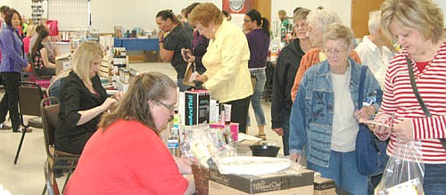 Ann Lutteke, far right, and Nancy Momeny, second from right, were among the hundreds of shoppers who searched for items at the annual "Spring Fling" at the Stewartville Civic Center on Saturday, April 16. Jean Dwire of Stewartville, who organized the event, said shoppers purchased items from 43 booths, which offered a wide variety of items.
