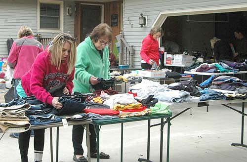 Shoppers at Stewartville's annual citywide garage sale came from at least two neighboring states last week. Trisha Hampton of Cassville, Wis., left, and Linda Weida of Riceville, Iowa, browse through the clothing at a multi-family sale at 506 Sixth Street Northeast on Thursday morning, May 5.