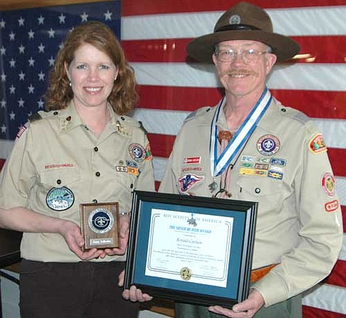 Amy Edholm and Ronn Carlson are two local Boy Scout leaders who have been honored for their work with youth. Edholm displays the District Award of Merit for her contributions to scouting at the district level. Carlson earned the Silver Beaver Award, given to individuals who have made a difference in the lives of youth through their service to the Boy Scout Council. Mark Ross and Corey Boelman, two other award winners, are not pictured.
